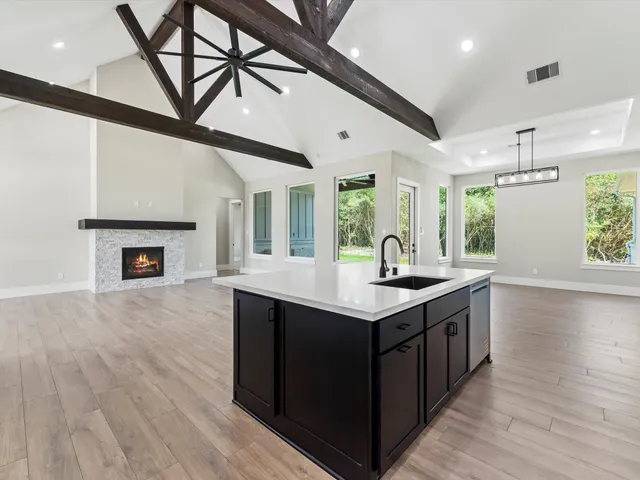 a spacious bedroom with a bed and a chandelier