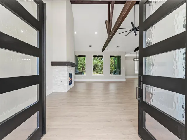 a living room with a fireplace a flat screen tv and a fireplace