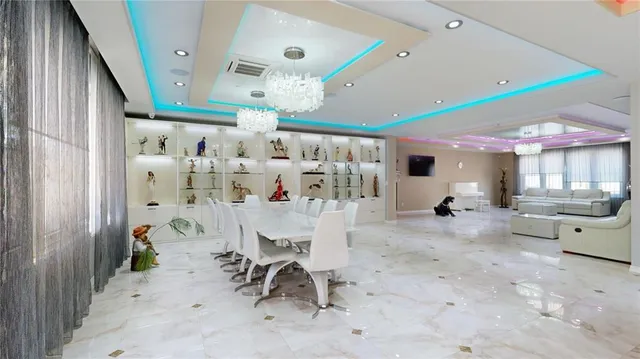 a view of a dining area with furniture and a chandelier