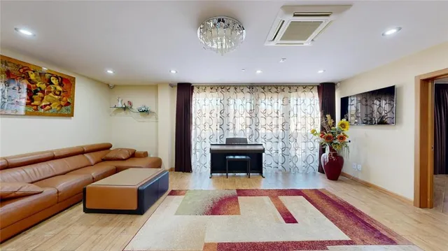 a living room with furniture and large window