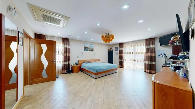 a living room with baby crib furniture and painting on the wall