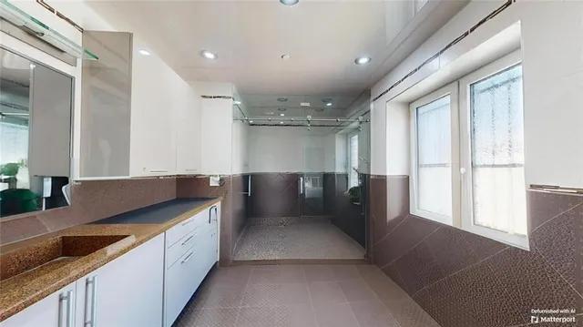 a living room with furniture and a book shelf