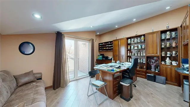 a living room with dining room and wooden floor