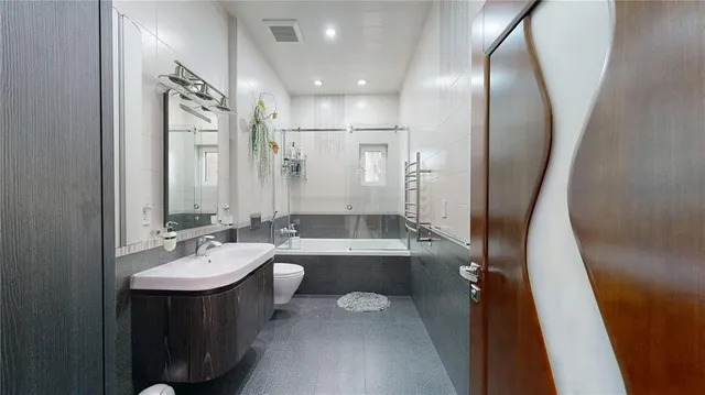 a spacious bedroom with a bed and a couch