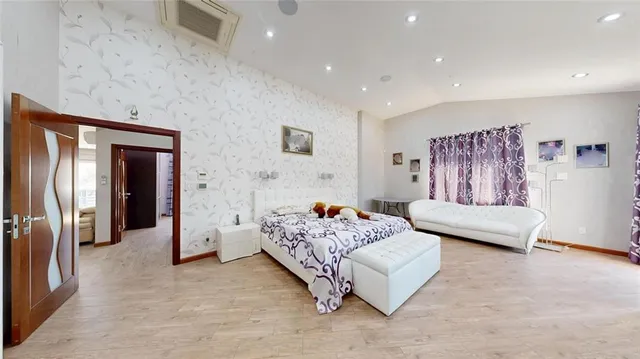 a bedroom with a large bed and a window