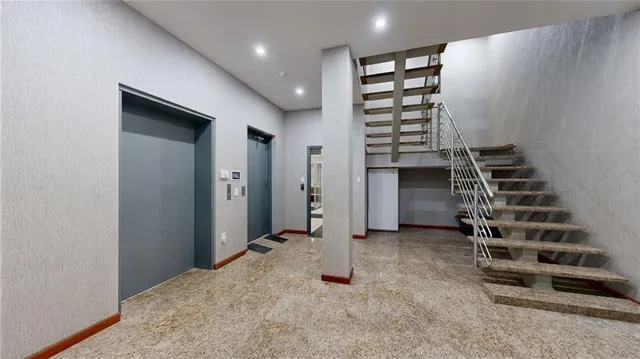 a view of a hallway with bathroom and glass door shower