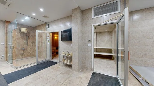 a large living room with stainless steel appliances kitchen island granite countertop furniture and a rug