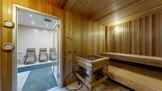 a large room with a large window and stainless steel appliances