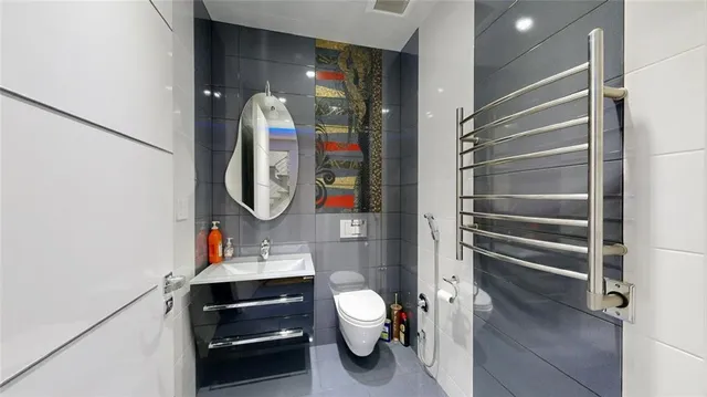 a bathroom with a toilet a sink and a mirror