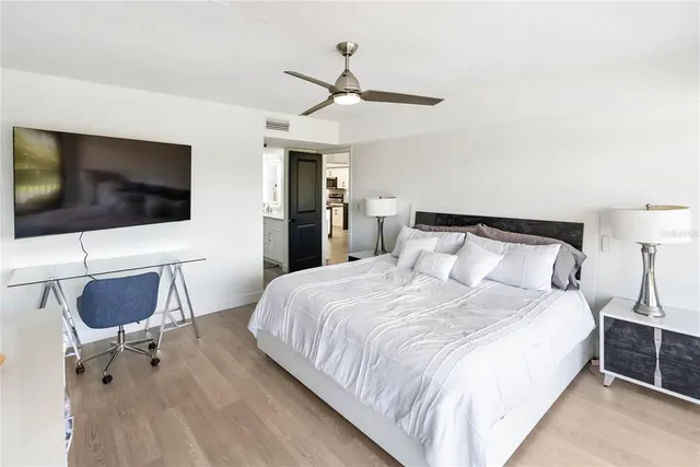 a spacious bedroom with a large bed and a desk