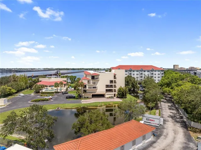 an aerial view of a house with outdoor space and lake view in back