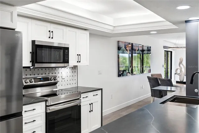 a kitchen with stainless steel appliances a refrigerator sink and cabinets
