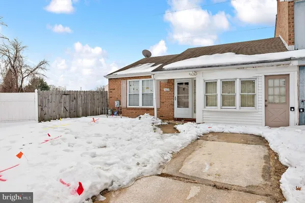 a view of a house with a wooden fence