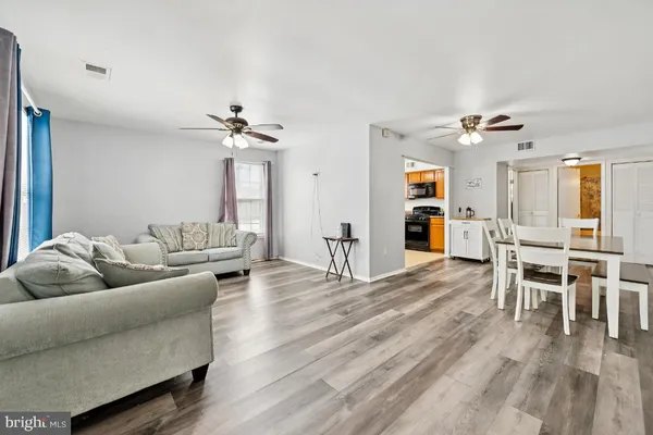 a living room with furniture and wooden floor