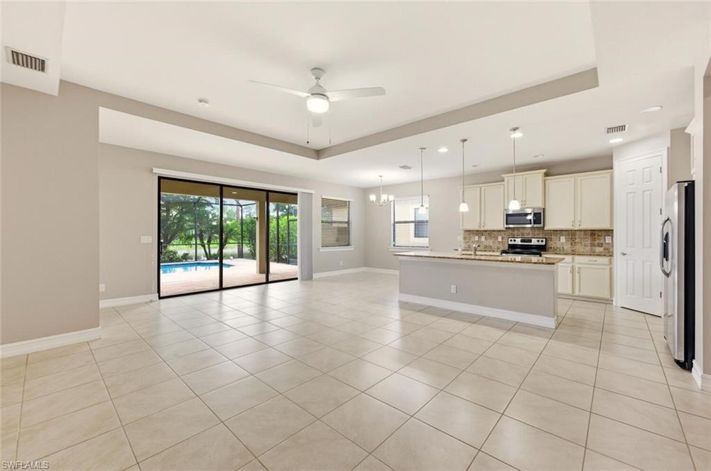 14513 Tuscany Pointe Trail Naples, FL 34120 - Photo 1 of 31 a large kitchen with cabinets and a stainless steel appliances