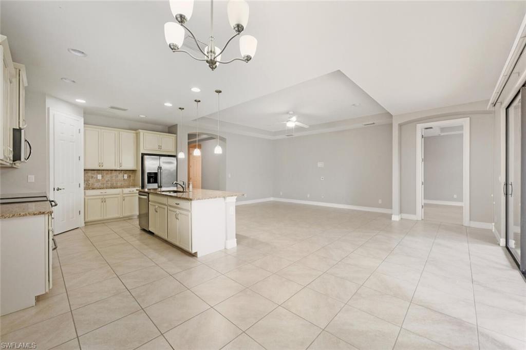 14513 Tuscany Pointe Trail Naples, FL 34120 - Photo 31 of 31 a kitchen with white cabinets and stainless steel appliances