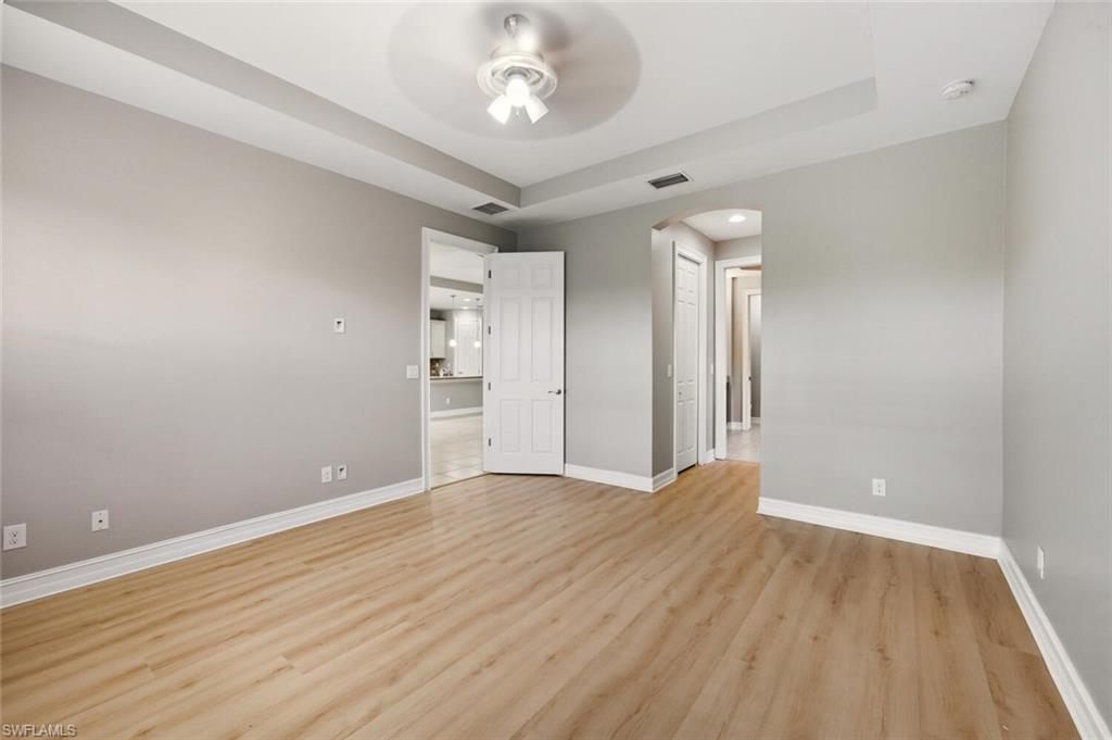 14513 Tuscany Pointe Trail Naples, FL 34120 - Photo 15 of 31 wooden floor in an empty room with a window