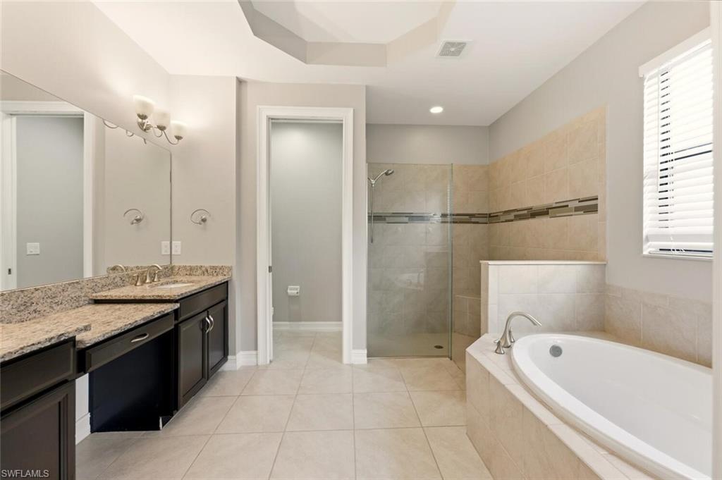 14513 Tuscany Pointe Trail Naples, FL 34120 - Photo 16 of 31 a bathroom with a granite countertop tub sink shower and mirror