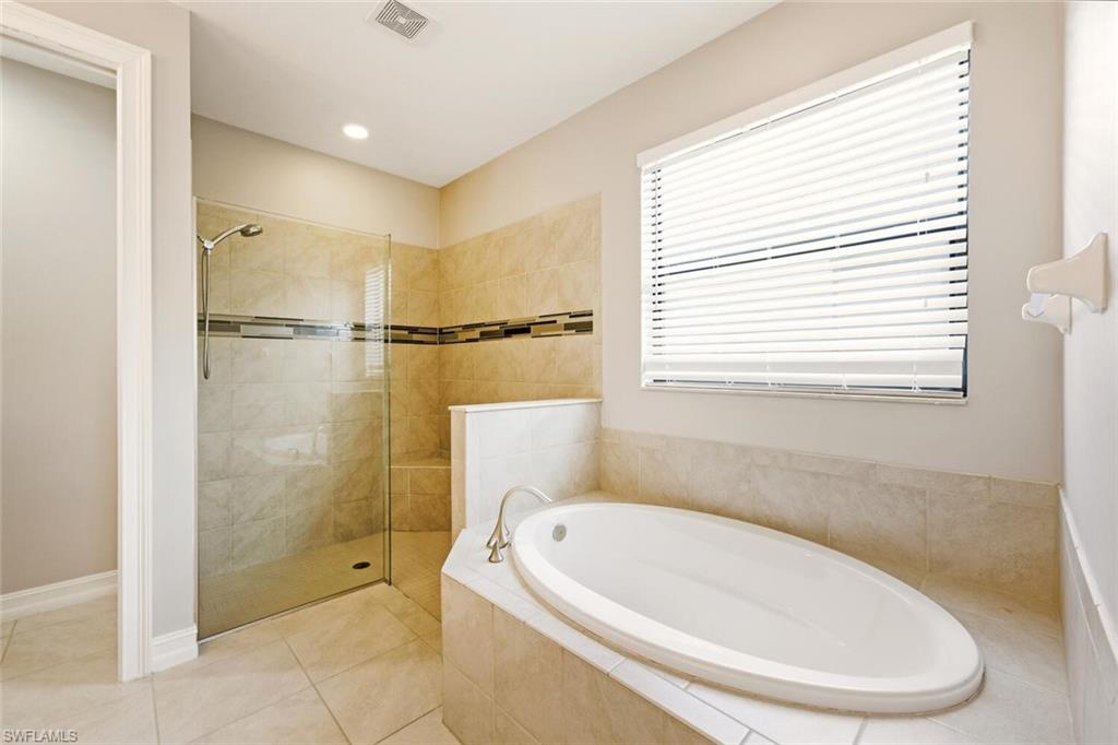 14513 Tuscany Pointe Trail Naples, FL 34120 - Photo 17 of 31 a bathroom with a tub a window and a shower