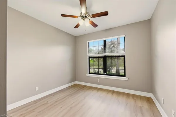 a bathroom with a tub a window and a shower