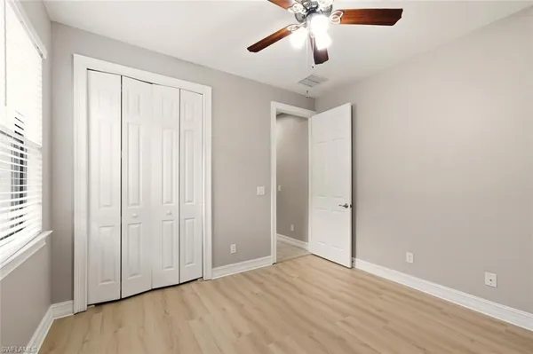 a bathroom with a granite countertop bathtub shower sink vanity and toilet