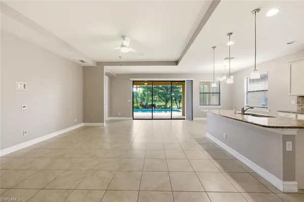 a large kitchen with granite countertop a large window and a sink