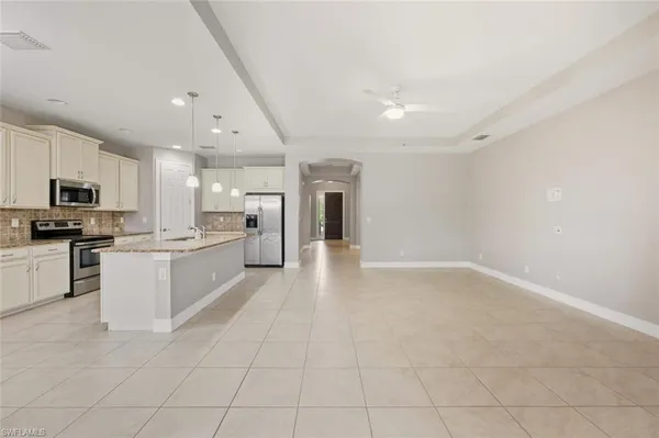 a large white kitchen with cabinets