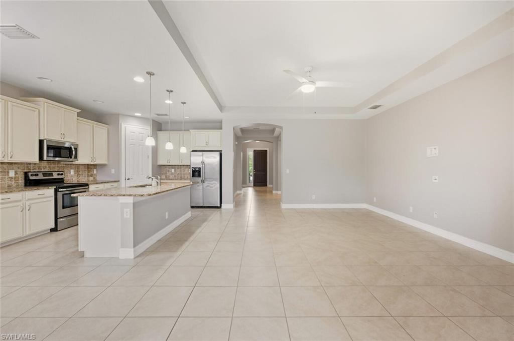 14513 Tuscany Pointe Trail Naples, FL 34120 - Photo 7 of 31 a large white kitchen with cabinets