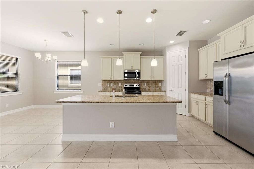 14513 Tuscany Pointe Trail Naples, FL 34120 - Photo 8 of 31 a large kitchen with kitchen island granite countertop a large counter top stainless steel appliances and cabinets