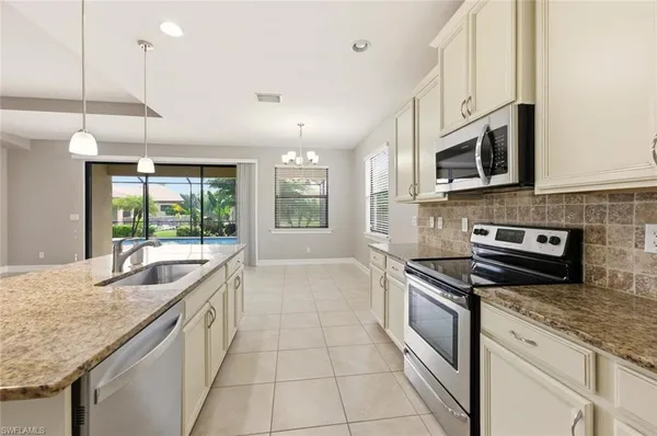 a large kitchen with kitchen island granite countertop a large counter top stainless steel appliances and cabinets