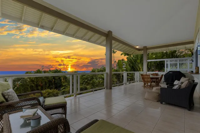 a view of a chair and tables in the balcony