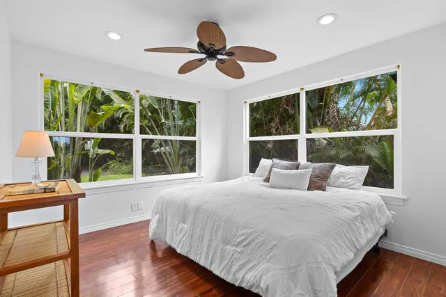 a bedroom with a large bed and a large window