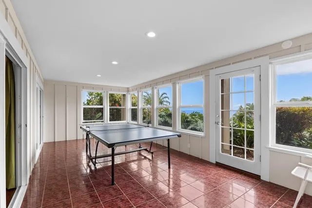 a room with pool table and windows