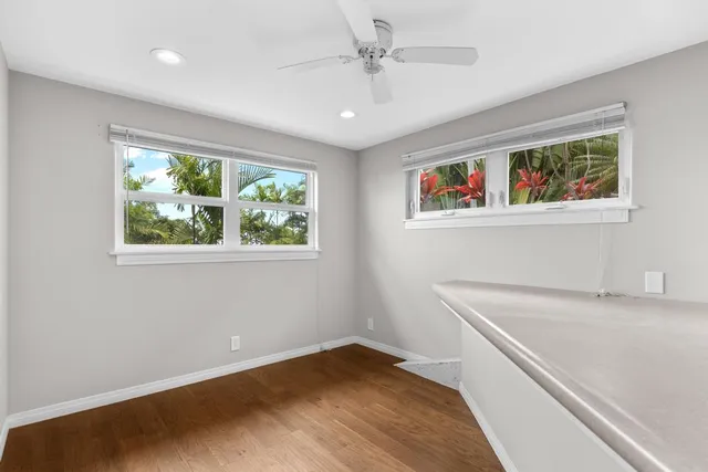 a room with a bed and a large window