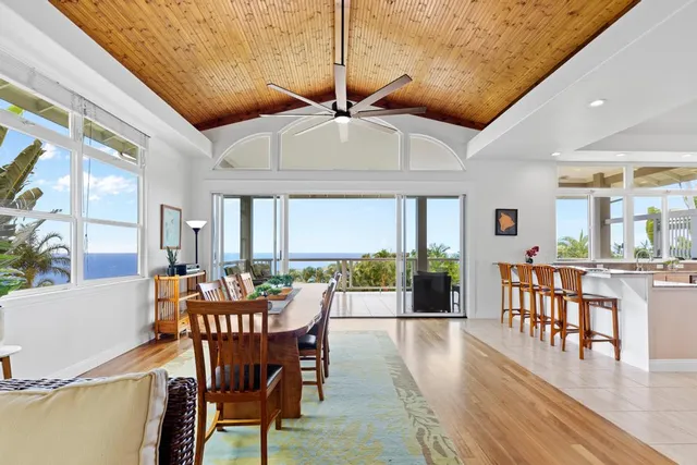 a dining room with furniture window and wooden floor