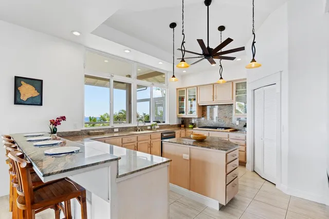 a kitchen with a stove a refrigerator and a sink