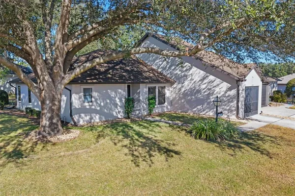 a view of a house with a yard and tree s
