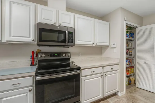 a kitchen with a sink and a refrigerator