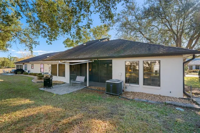 a view of a backyard with a patio and a garden