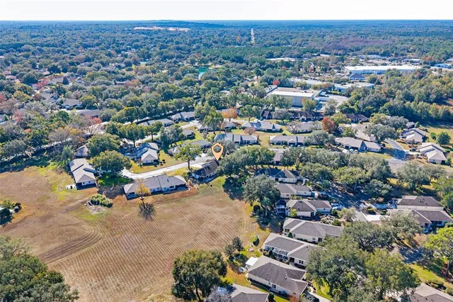 an aerial view of a house with a yard and garden