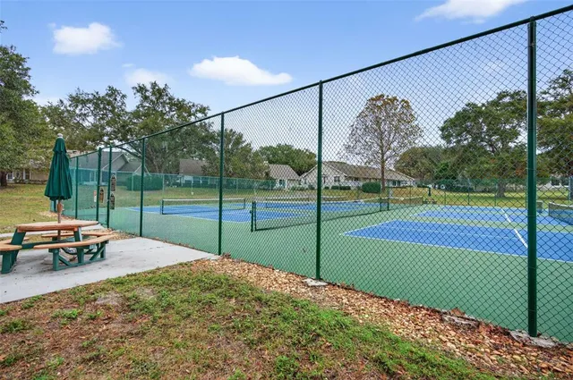 a room with pool table and large windows