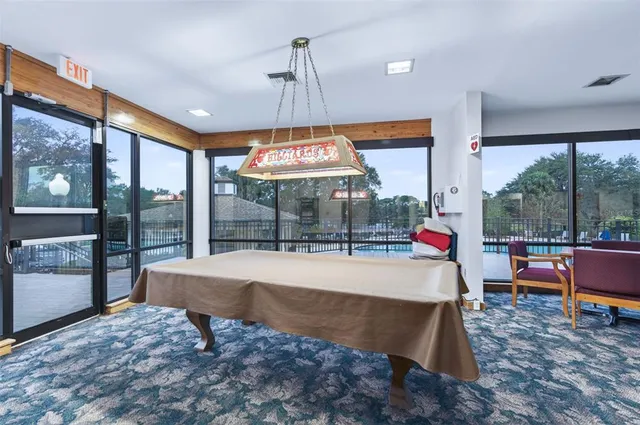 a view of a lake with a big yard and a large trees