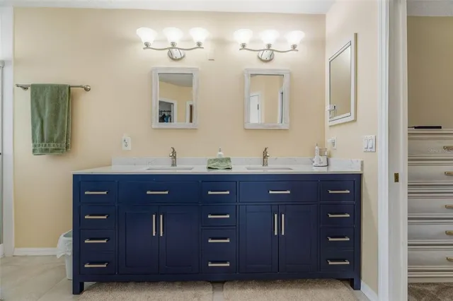 a bathroom with a sink double vanity and a mirror