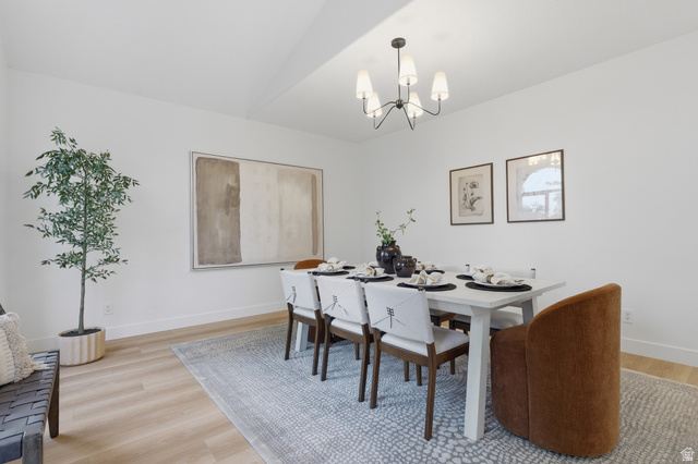 702 Alpine Highway Alpine, UT 84004 - Photo 21 of 83 Spacious room featuring light wood-finish flooring, a contemporary chandelier, white walls, and a decorative area rug