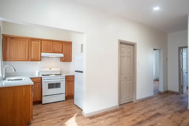 a kitchen with a stove top oven sink and cabinets