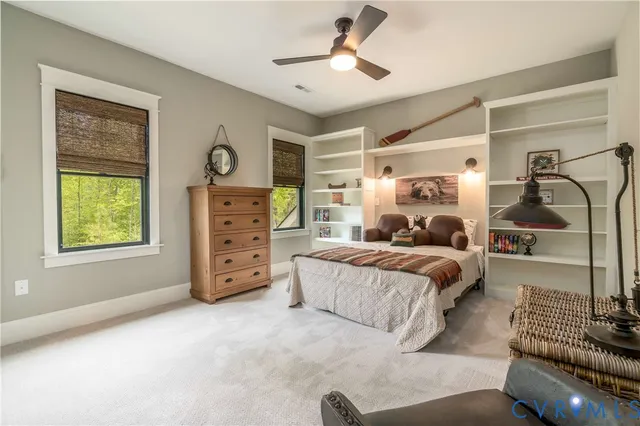 a bedroom with a bed couch and window