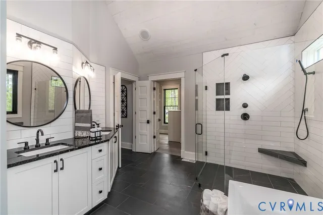 a en suite bathroom with a double vanity sink and a mirror