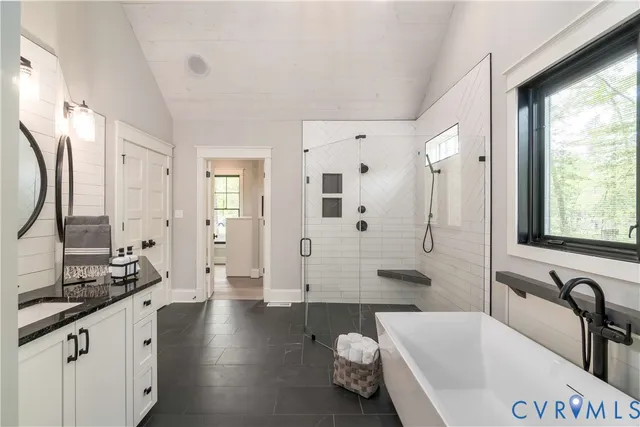 a view of hallway with window and a refrigerator