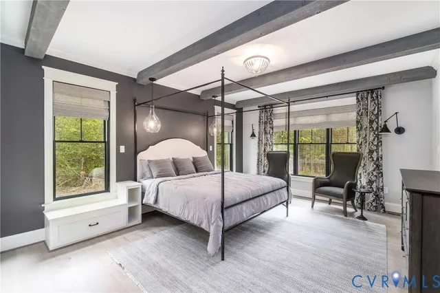 a dining room with furniture a chandelier and wooden floor