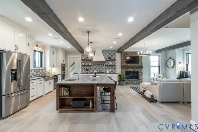 a kitchen with granite countertop a table and chairs in it